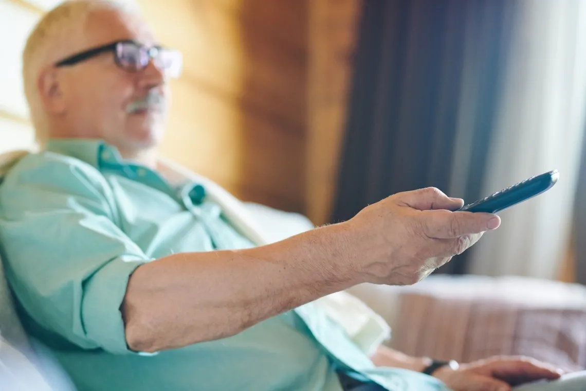 Older man watching TV