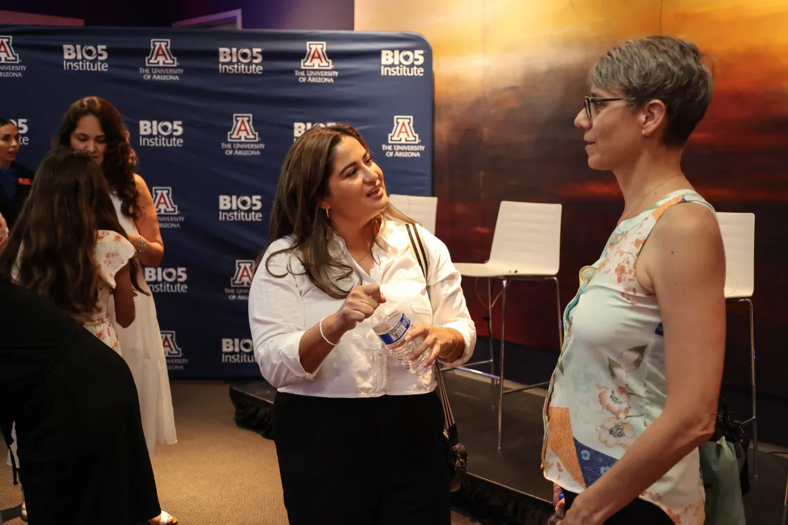 Two women speaking at an event