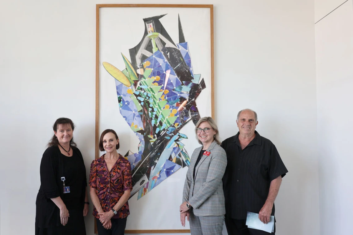 Group of people standing in front of Marvin Lowe Artwork