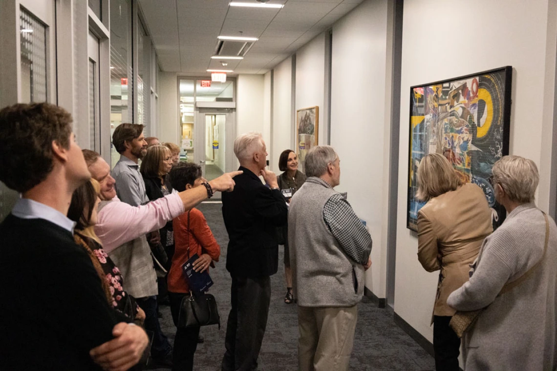 Group of people admiring Marvin Lowe artwork at the BIO5 Institute