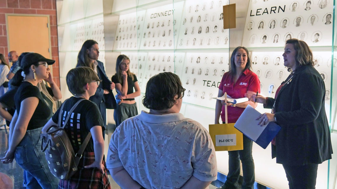 Group of people listen as a tour guide describes the BIO5 Institute