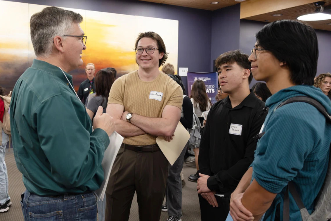 Three people talking at a networking event at the BIO5 Institute
