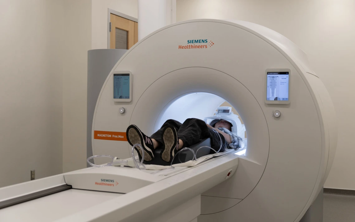 Person undergoing a scan in a Siemens Healthineers MRI machine.