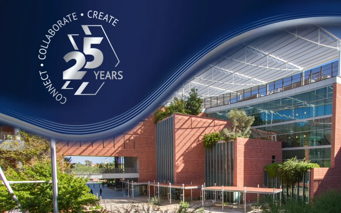 A modern building with large windows and a brick facade is surrounded by greenery under a clear sky. In the top left corner, there is a blue graphic with the text: "Connect • Collaborate • Create 25 Years.