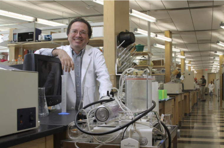 Dr. Fernando Martinez in his lab smiling at the camera