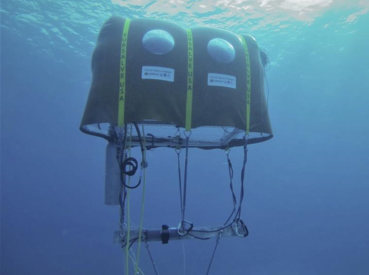 The Ocean space habitat resting underwater and features a UofA logo