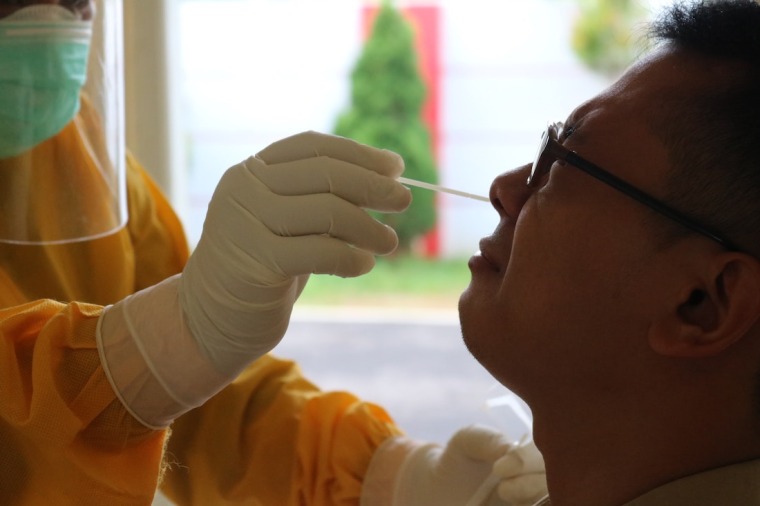 Man getting a nasal swab from a doctor