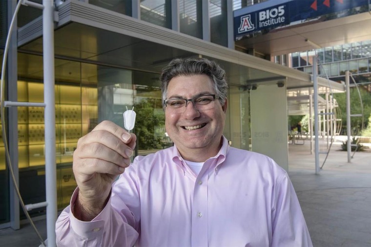 Dr. Klearchos Papas holding a bioartificial pancreas.