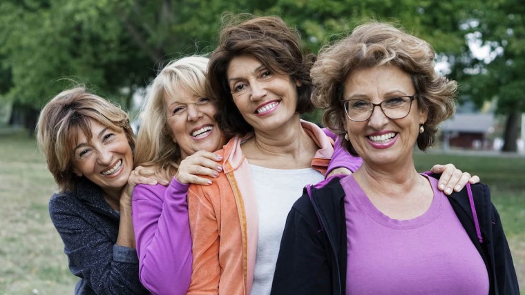4 women smiling.