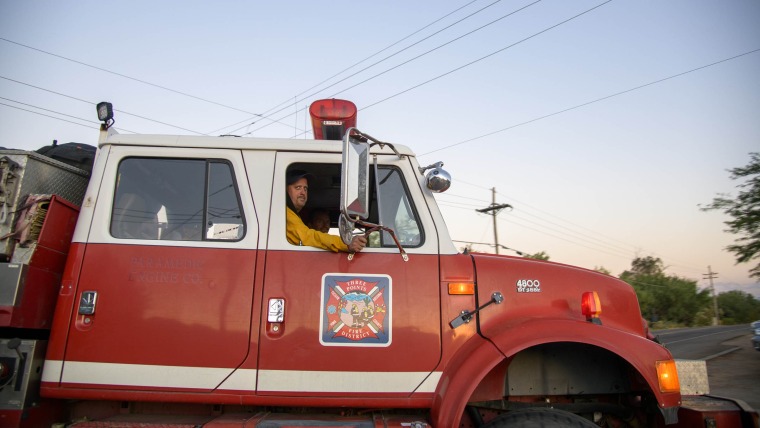 Firefighters in a firetruck.