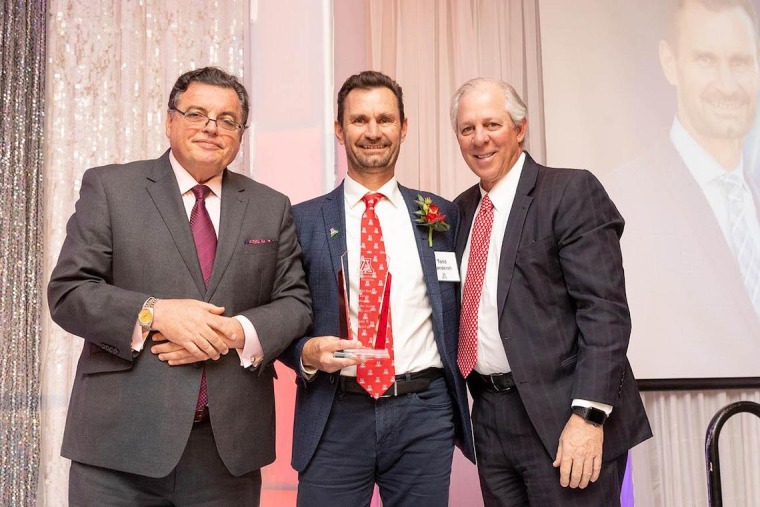 (From left) Michael M. I. Abecassis, MD, MBA, dean of the UArizona College of Medicine – Tucson; Todd Vanderah, PhD, professor and department head of the UArizona College of Medicine – Tucson’s Department of Pharmacology; and UArizona President, Robert C. Robbins, MD, pause for a photo at the Alumni of the Year awards celebration.