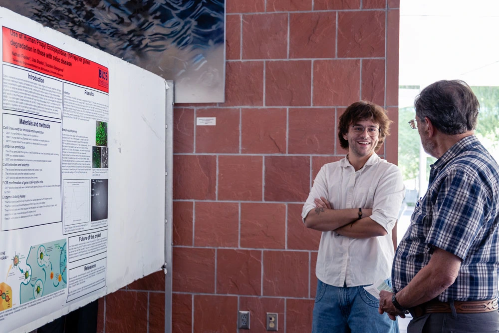 Two individuals discussing a scientific poster at a conference held at the BIO5 Institute