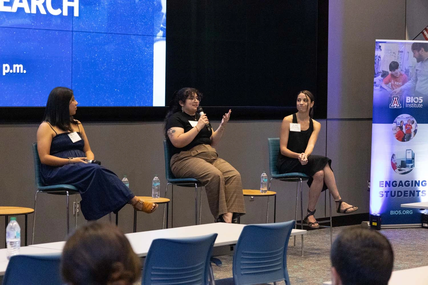 Group of panelists presenting at the front of the room