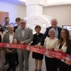 Group of individuals holding University of Arizona banners in front of an MRI machine.