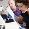 Two scientists using specialized laboratory equipment at the University of Arizona, Agricultural and Life Sciences facility.
