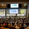 Group of people sitting in a large room with a screen that reads "PFAS"