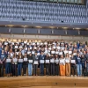 Group of students standing with certificates in the auditorium