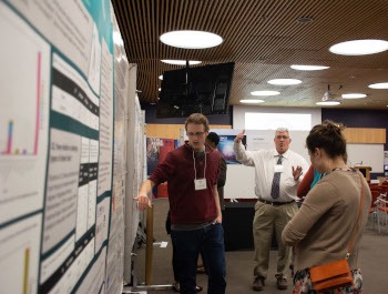 Student presenting a poster at the showcase